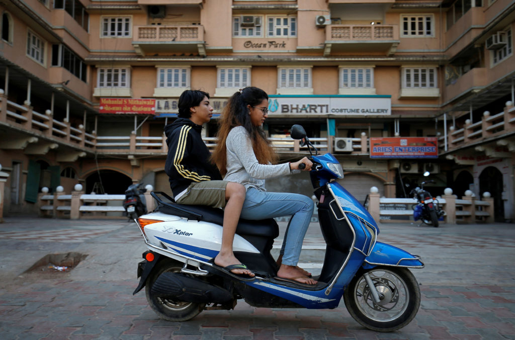 Girls ride an electric scooter in Ahmedabad, India, December 30, 2018. Photo by REUTERS/Amit Dave